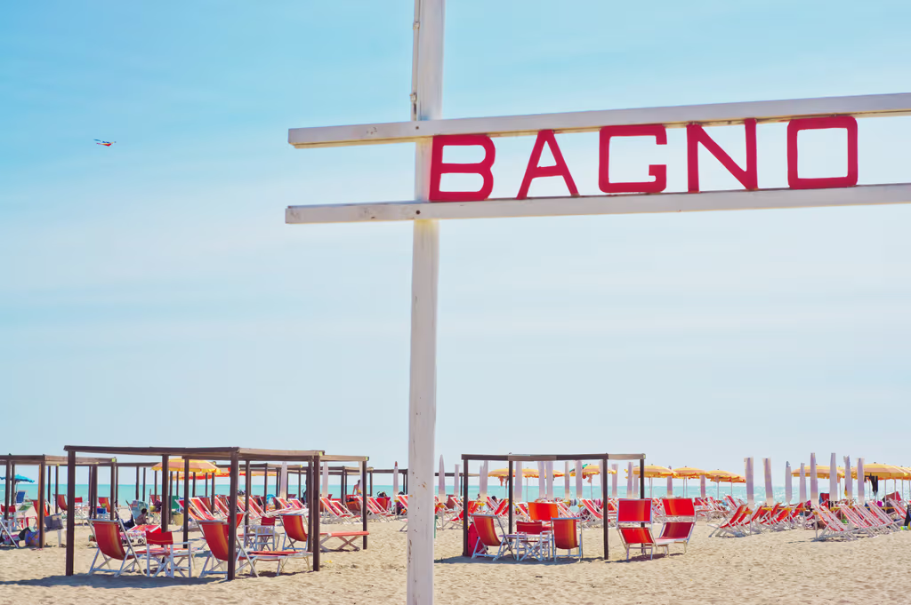 Tented beach chairs along the seaside in Versilia.