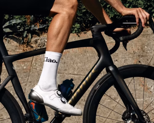 Close up of bike frame and white socks.